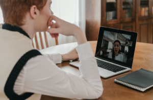 Telehealth therapy patient speaking to therapist over computer conferencing
